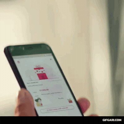 Person Looking At Gift Box On Phone GIF