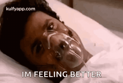 Person Lying In Hospital Bed With Oxygen Mask GIF