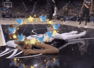 Person Lying On Basketball Court With Birds And Stars GIF