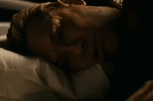 Person Lying On Bed With American Flag Blanket GIF