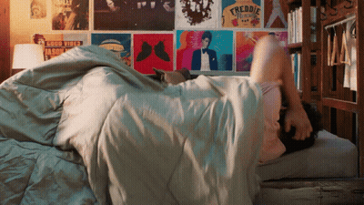 Person Lying On Bed With Freddie Mercury Poster GIF