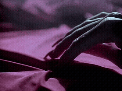 Person Lying On Bed With Pink Sheet GIF