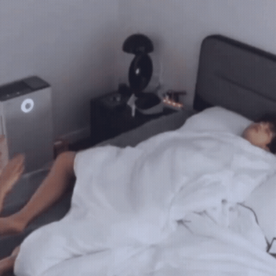 Person Lying On Bed With White Sheets GIF