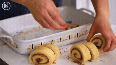 Person Making Cinnamon Rolls In Casserole Dish GIF