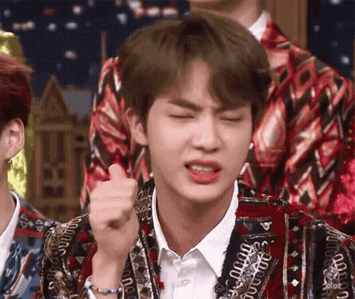 Person Making Funny Face In Colorful Jacket GIF