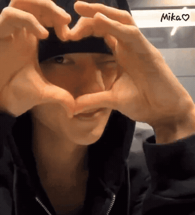 Person Making Heart Shape With Hands Saying Mika GIF