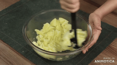 Person Mashing Potatoes In Glass Bowl GIF