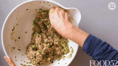 Person Mixing Food In Bowl With Number 52 GIF