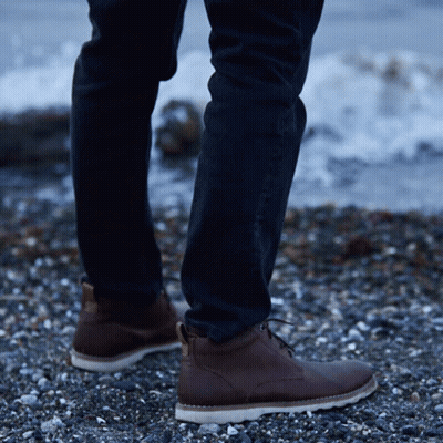 Person On Rocky Beach In Brown Boots GIF