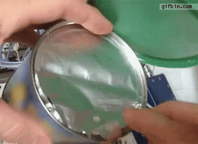 Person Opening Can With Magnifying Glass Gifbin GIF