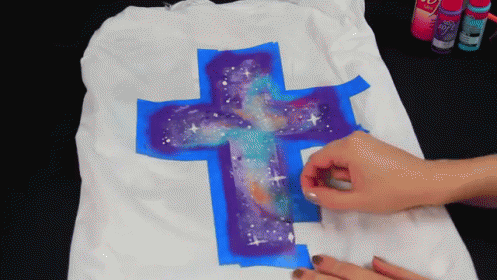 Person Painting Cross With Galaxy Design