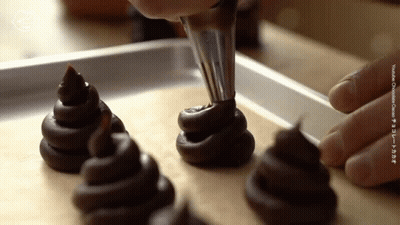 Person Piping Chocolate Cookies GIF
