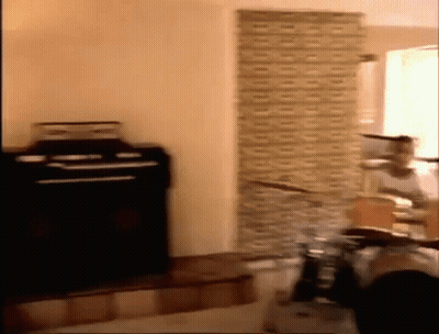 Person Playing Drums In Brick Wall Room GIF