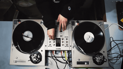 Person Playing Records on Technics Turntables