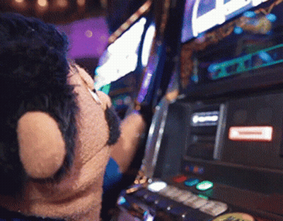 Person Playing Slot Machine With Red A Sticker GIF