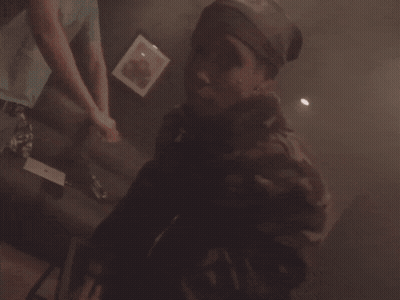 Person Playing Video Game In Dark Room With Purple Lights GIF