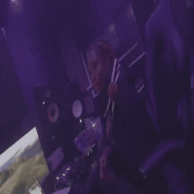 Person Playing Video Game In Dark Room With Purple Lights GIF