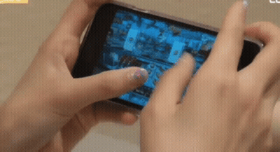 Person Playing Video Game On Cell Phone GIF