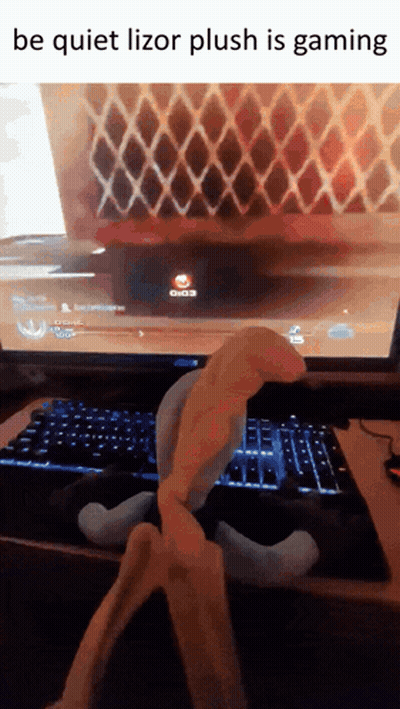 Person Playing Video Game With Lizor Plush GIF