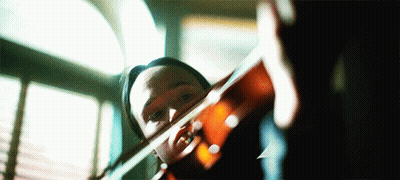 Person Playing Violin In Front Of Window GIF