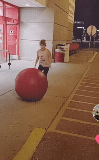 Person Playing With Large Red Ball GIF