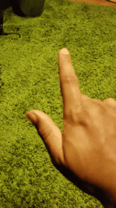 Person Pointing Thumb at Green Carpet