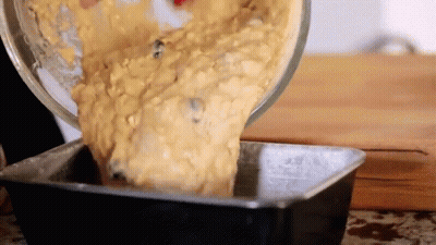 Person Pouring Batter Into Loaf Pan GIF