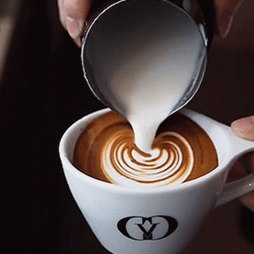 Person Pouring Milk Into Cup Of Coffee GIF