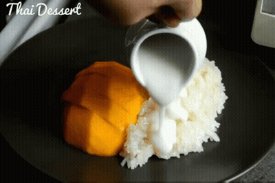 Person Pouring Milk On Thai Dessert GIF