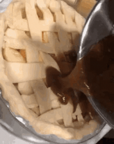 Person Pouring Sauce Into Pie GIF