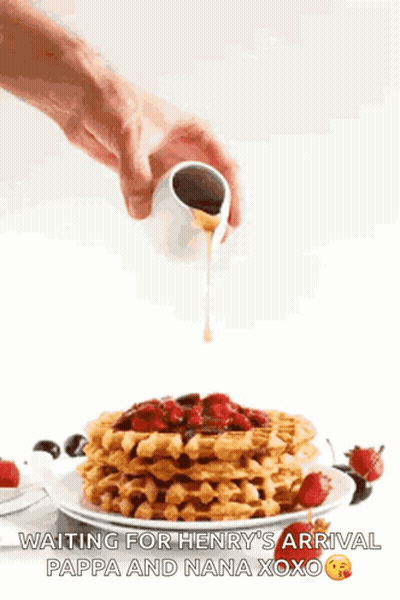 Person Pouring Syrup Over Waffles With Strawberries GIF