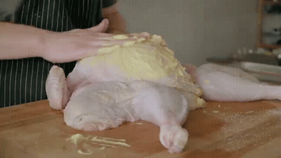 Person Preparing Chicken On Cutting Board GIF