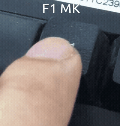 Person Pressing F1 Key On Black Keyboard GIF