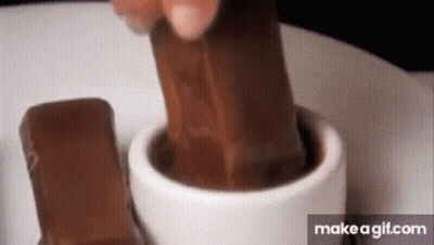 Person Putting Chocolate Bar In Hot Chocolate GIF