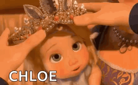 Person Putting Crown On Doll GIF