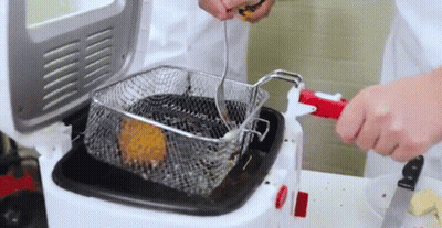 Person Putting Food Into Fryer GIF