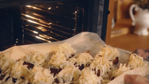 Person Putting Food With Cheese In Oven GIF