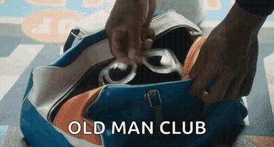 Person Putting Glasses In Old Man Club Bag GIF