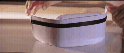 Person Putting On White Hat With Black Ribbon GIF