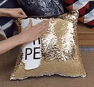 Person Putting Pillow With Peace On Couch GIF