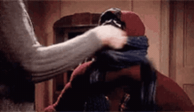 Person Putting Scarf Around Another's Neck GIF