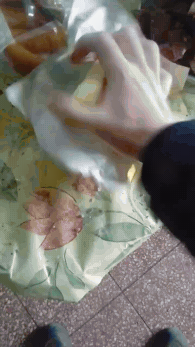 Person Putting Something In A Plastic Bag GIF