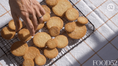 Person Reaching For Cookie On Wire Rack Food52 GIF