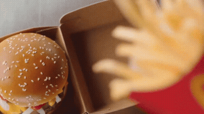Person Reaching For Hamburger And Fries GIF