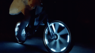 Person Riding Bicycle With Glowing Wheels At Night GIF