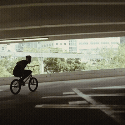 Person Riding Bike In Parking Garage GIF