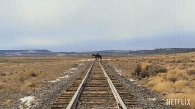 Person Riding Horse On Train Track With Netflix Logo GIF