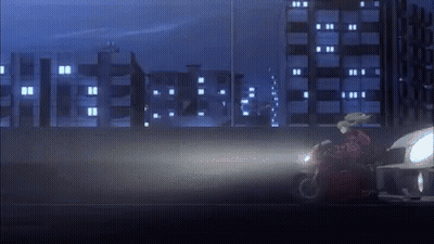 Person Riding Motorcycle Down Road At Night GIF