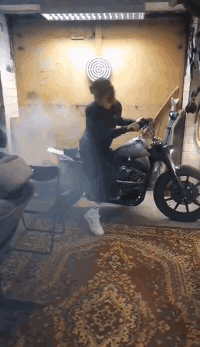 Person Riding Motorcycle In Garage With Smoke GIF