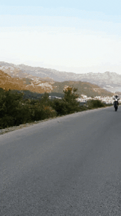 Person Riding Motorcycle On Empty Road GIF